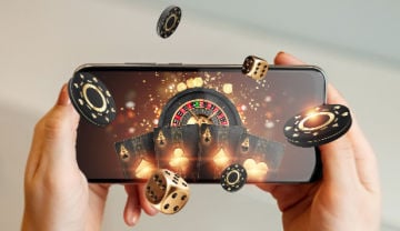 roulette wheel on mobile screen with chips and dice flying out of the screen