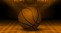 basketball sitting on a court with a Home - Guest sign behind