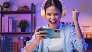girl with earphones playing a mobile game