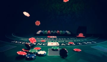 blackjack table at a casino with chips flying around