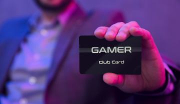 Man holding a VIP card that says Gamer Club Card