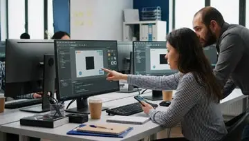 two game developers working on a new mobile platform 