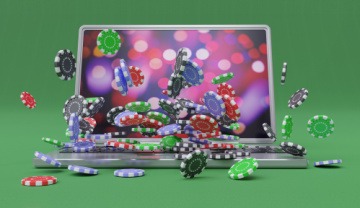 an open laptop with casino chips flying out of it