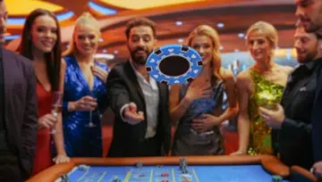 group of friends standing at the gambling table with a big blue chip flying through the air