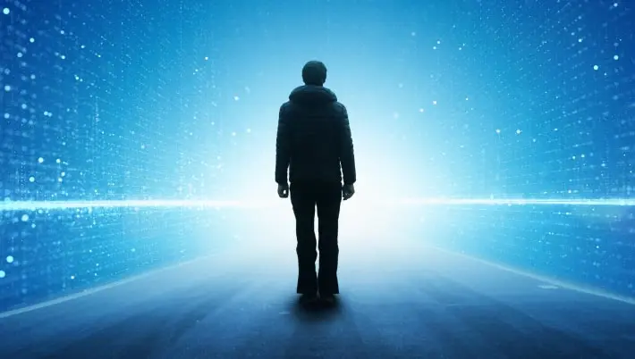 silhouette of a man standing against a futuristic background