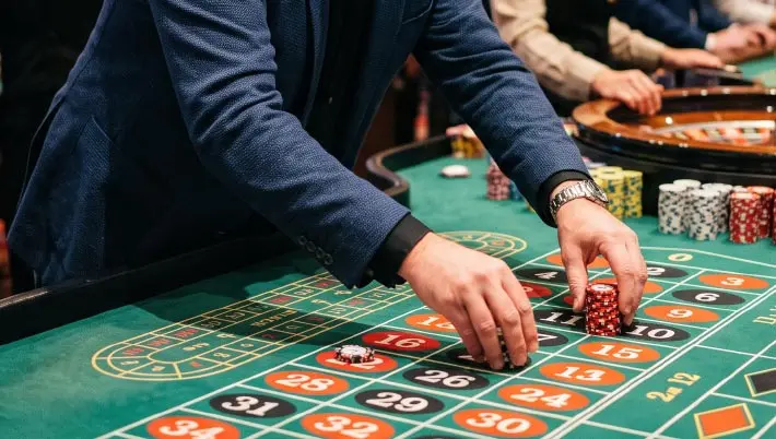 man placing chips on a casino table
