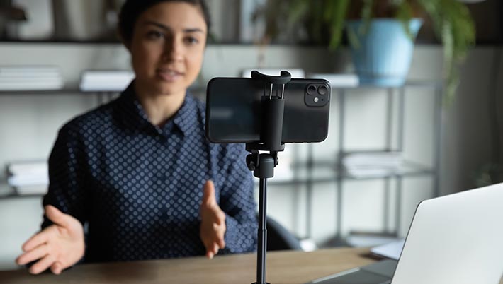 An influencer preparing a recording on her smartphone