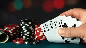 poker hand with a straight flush of clubs