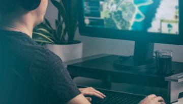 young man playing games on a PC  