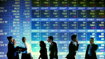 business stock exchange board with traders standing in front of it doing business