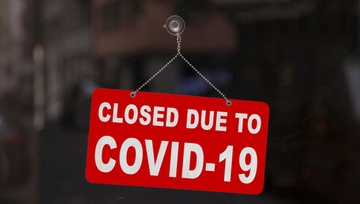 sign on a glass door:  Closed due to Covid-19