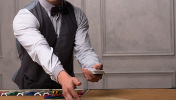dealer dealing cards at a casino poker table