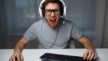 a gamer excitedly playing a video or Grande Vegas online casino game on his sofa