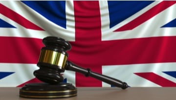 gavel on a desk with a British flag in the background