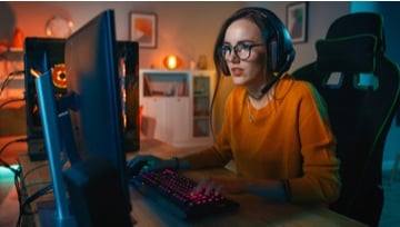 Girl playing video game while commenting and interacting with fans
