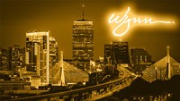 the skyline of Boston with a Wynn resorts logo in the corner