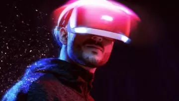 a young man with a VR set on and a starry night backdrop behind him