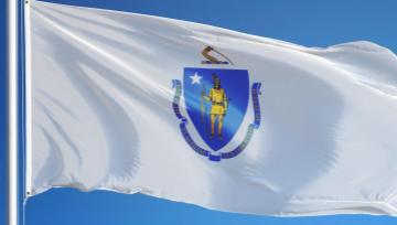Massachusetts flag on a flag pole waving in the wind