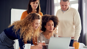 people gathered together around a computer