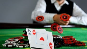 poker player throwing chips into the pot showing 2 Aces