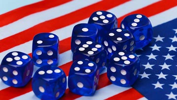 White and blue dice sitting on an American flag