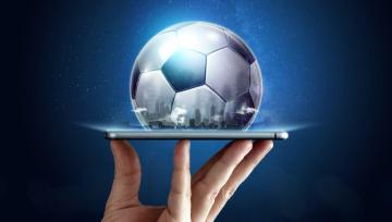 soccer ball on perched on a mobile phone