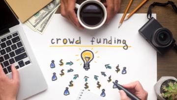 team sitting together trying to figures out crowdfunding