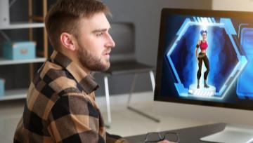 video game designer at work in front of several computer screens
