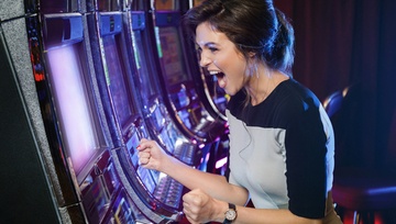 woman playing casino slot machine