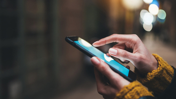 woman's hands using a mobile phone